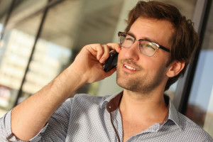 Portrait of a handsome man having phone conversation