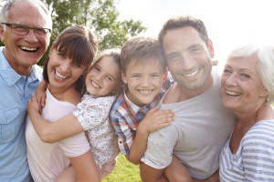 Multi Generation Family Giving Children Piggybacks Outdoors